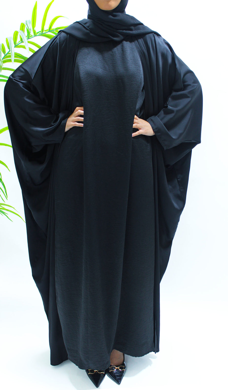 Full-length view of Amani's black farasha abaya set