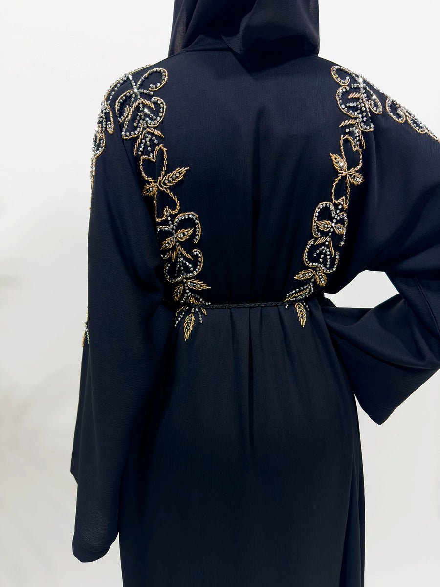 Black hand embellished abaya shown with its matching hijab and belt