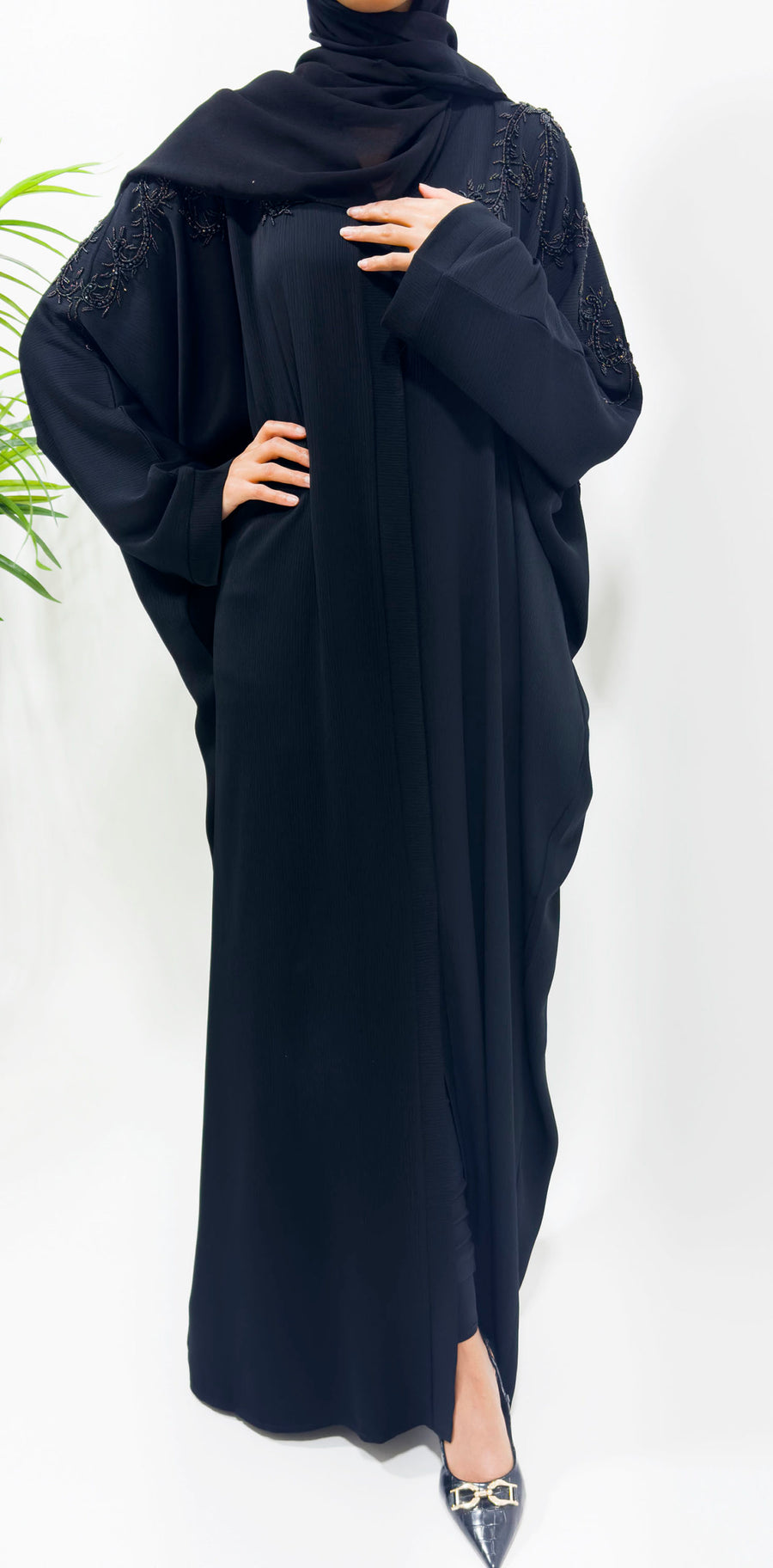Back of the black batwing abaya showing hand-stitched beading on the shoulders