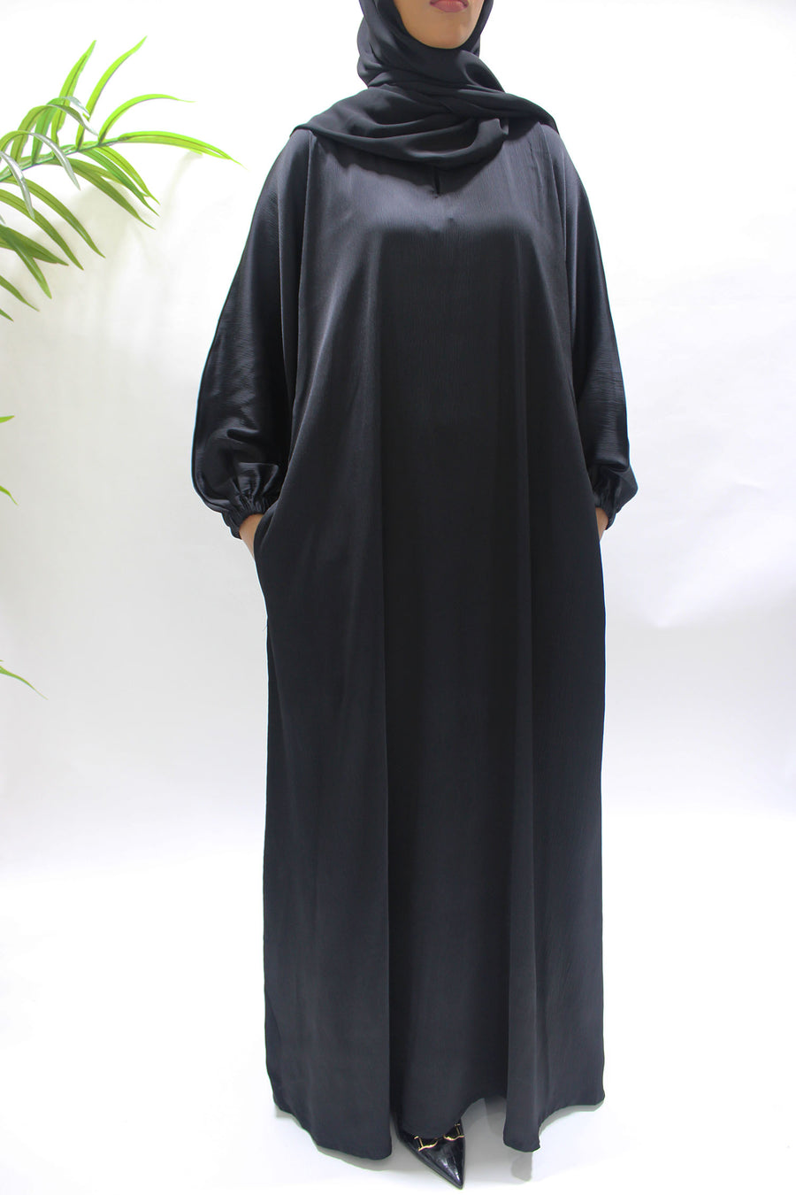 Side pocket on the black textured satin abaya