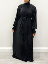 Black pleated satin turtleneck maxi dress, full-length front view