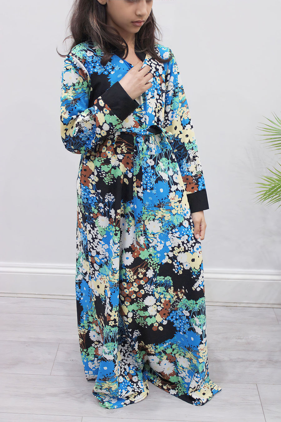 Full-length view of Amani's blue floral kids maxi dress