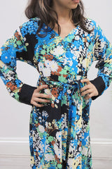 Girl wearing Amani's blue floral umbrella-cut kids maxi dress