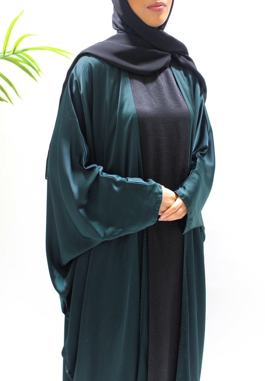 Textured satin detail on the bottle green farasha abaya