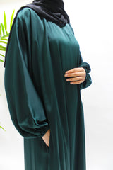 Woman wearing Amani's bottle green textured satin abaya with matching hijab