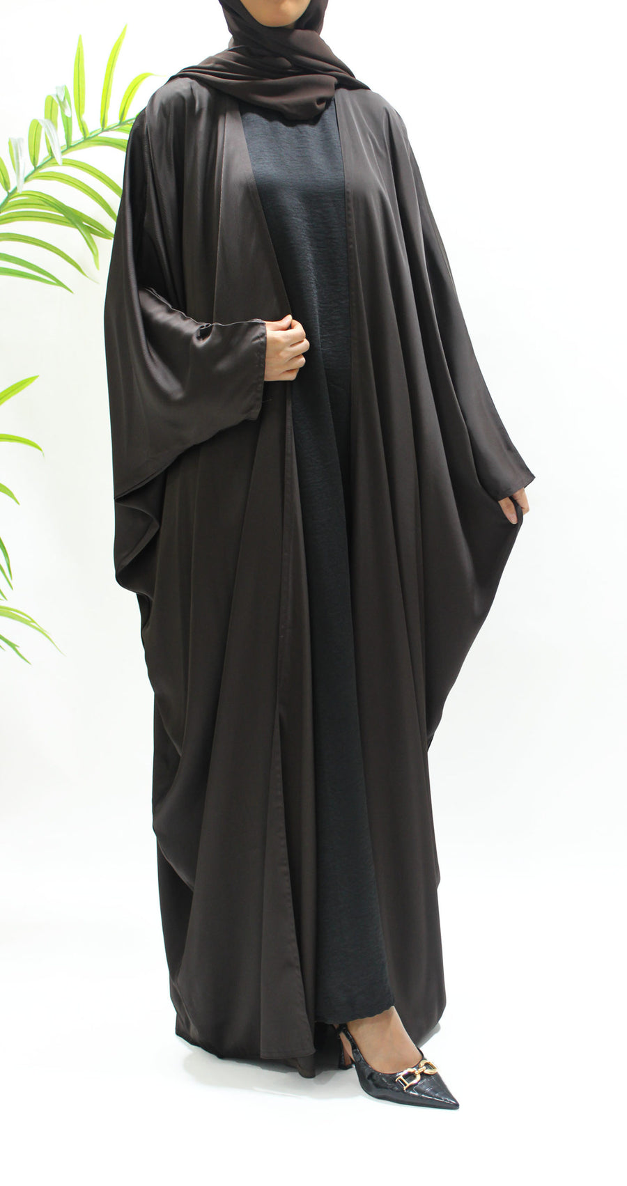Woman wearing Amani's brown farasha abaya set with matching hijab