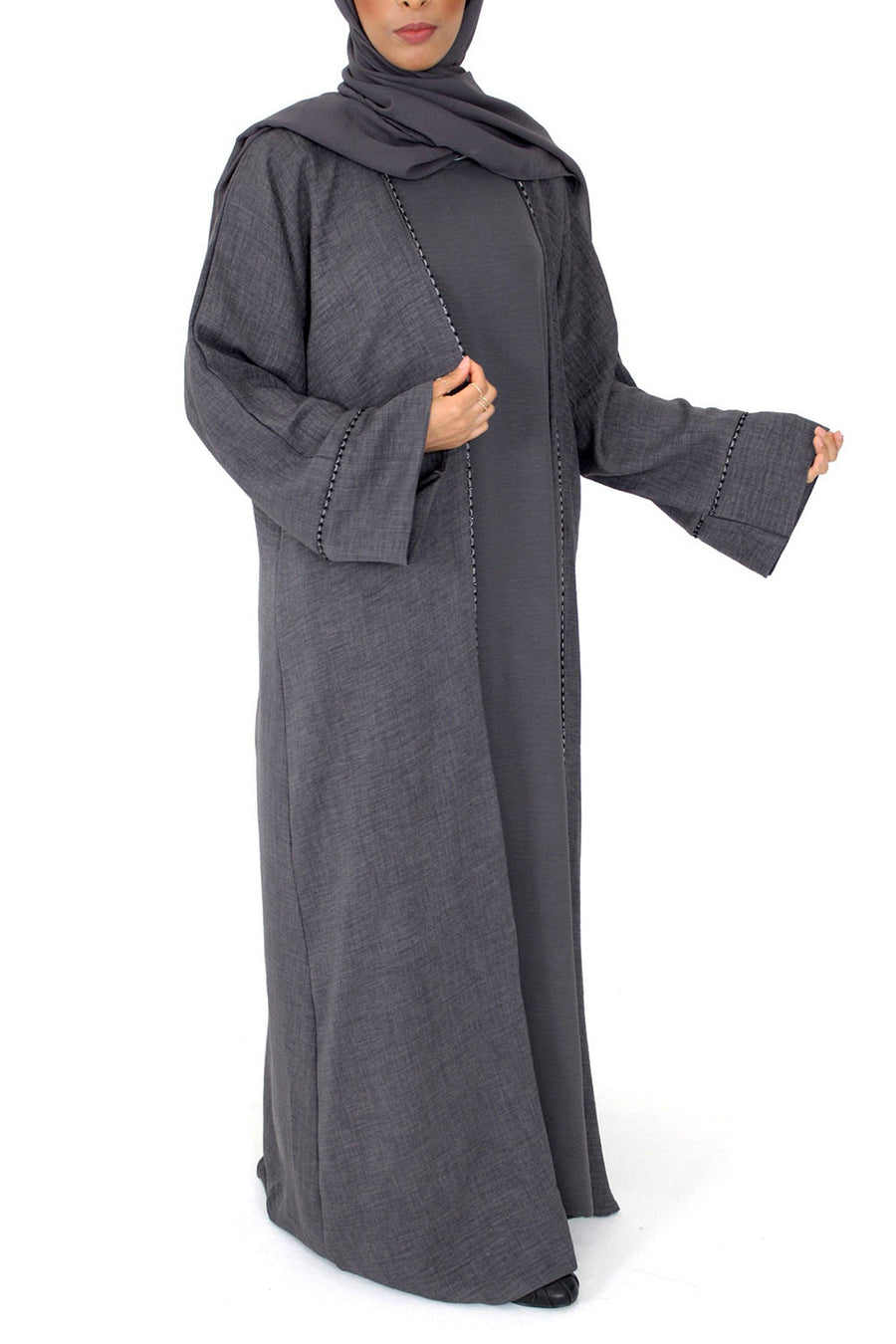 Charcoal grey open abaya layered over the matching inner dress