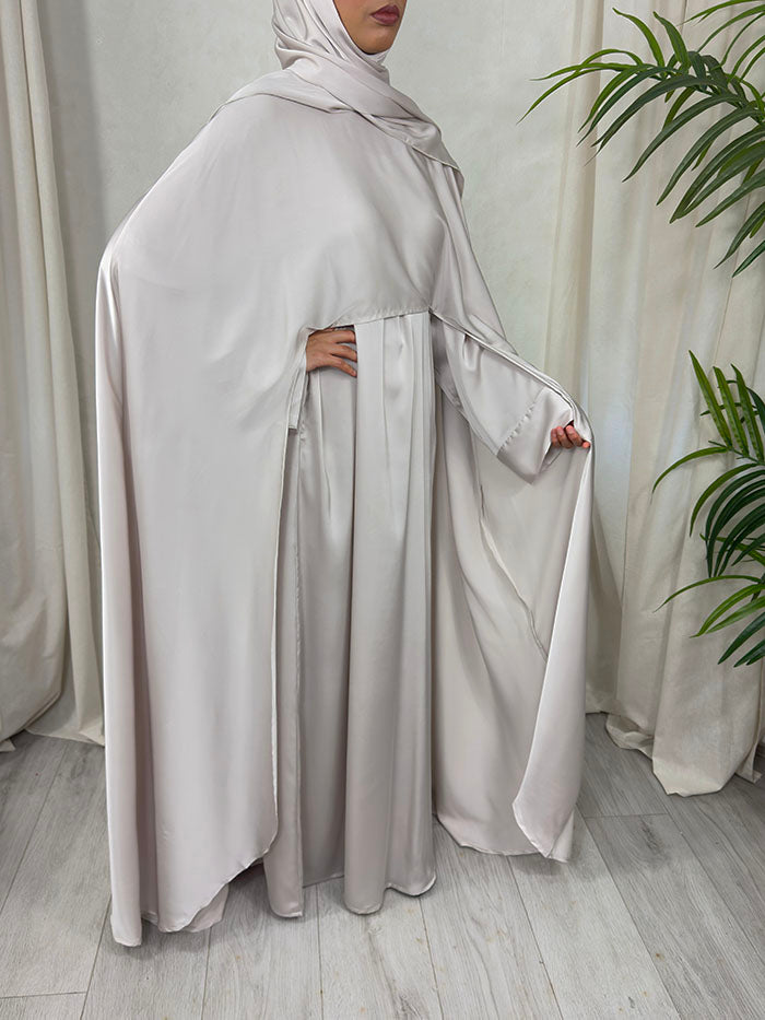 Nude open cape layered over the inner abaya, showing the floor-skimming drape