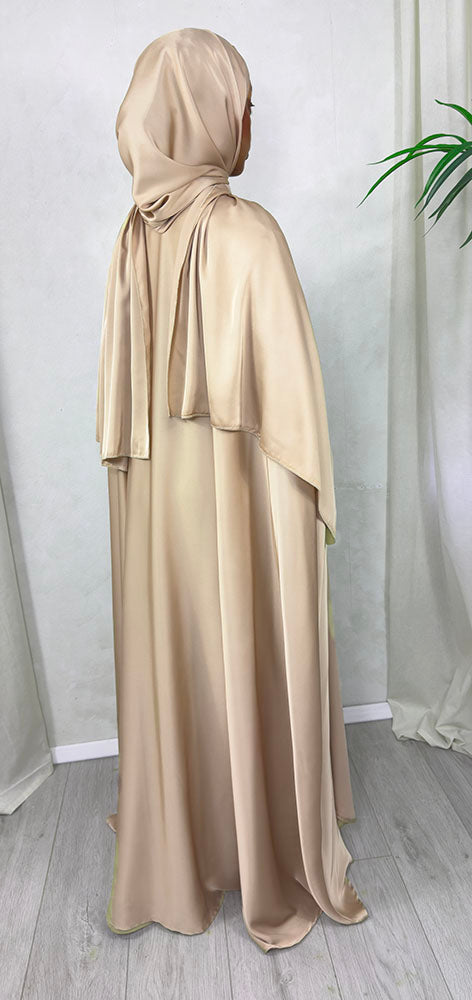 Warm beige cape abaya set side view showing the flowing satin cape and adjustable waist belt