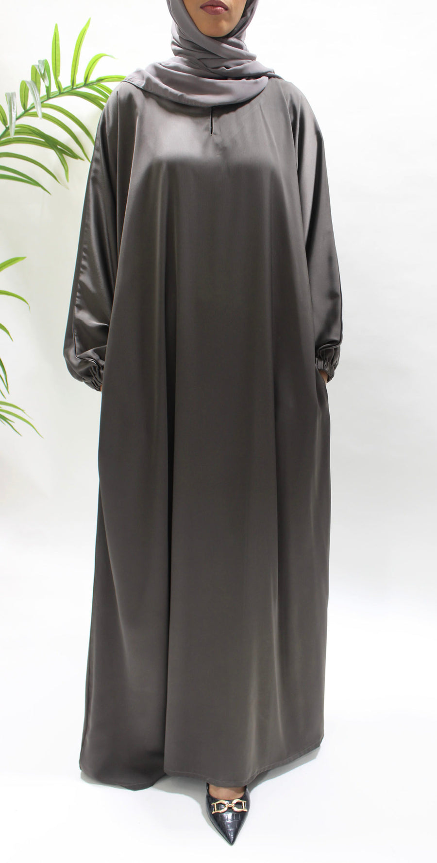 Textured satin fabric detail on the dark taupe abaya