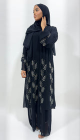 Woman wearing Amani's black double chiffon embellished open abaya