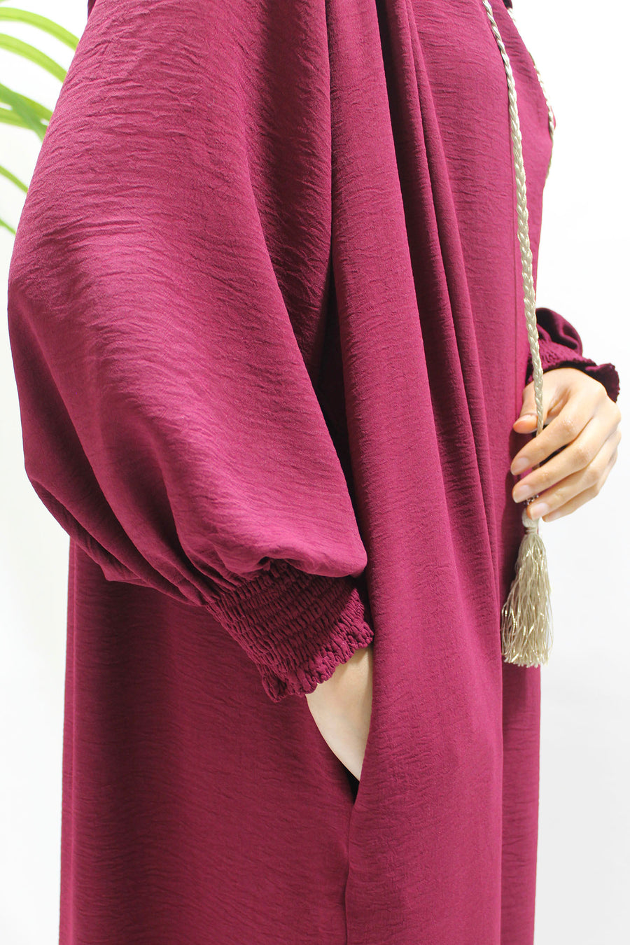 Burgundy prayer abaya showing the ruched cuffs for wudu