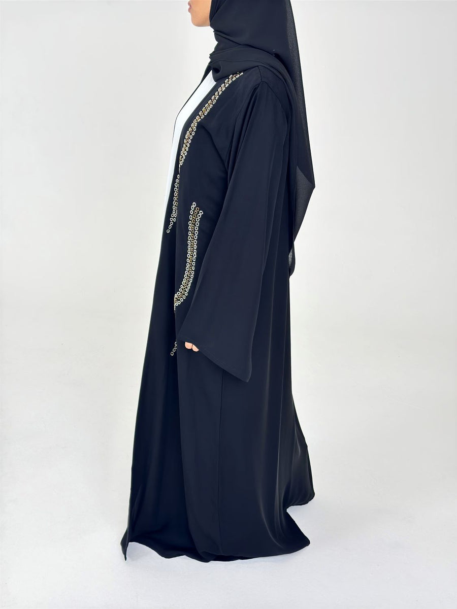 Black duster abaya styled over an outfit