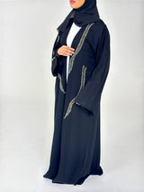 Woman wearing Amani's embellished black duster style abaya with scarf