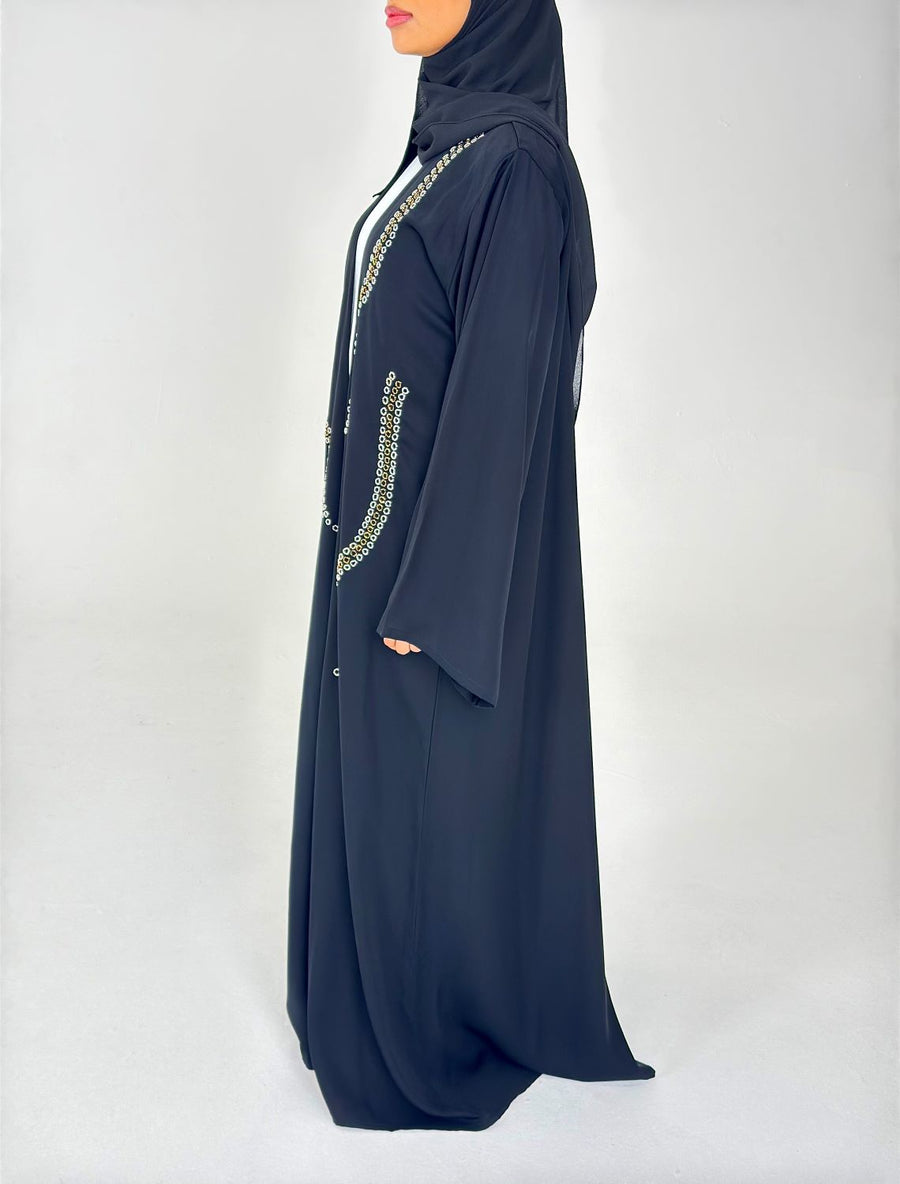 Full-length view of Amani's black duster style abaya