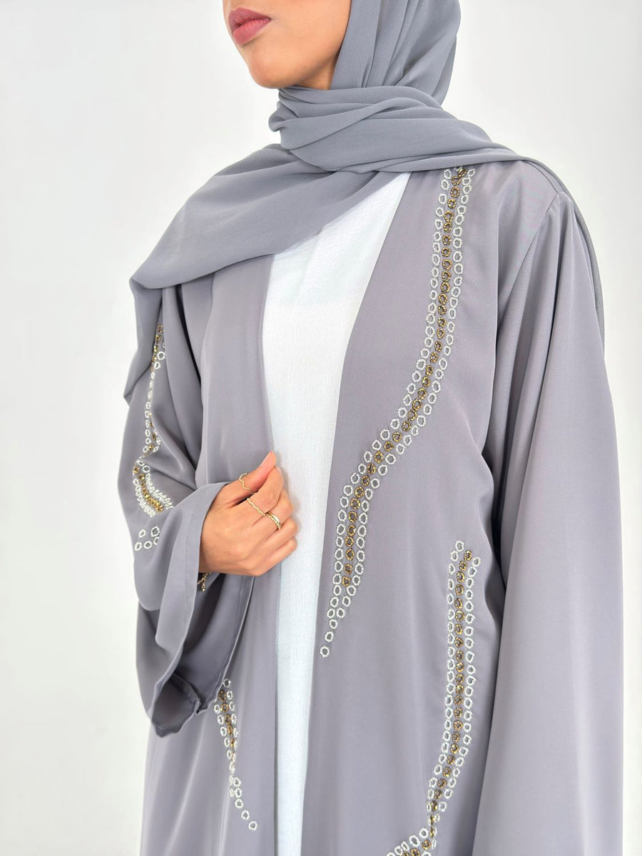 Gold and silver embellishment on the grey duster abaya