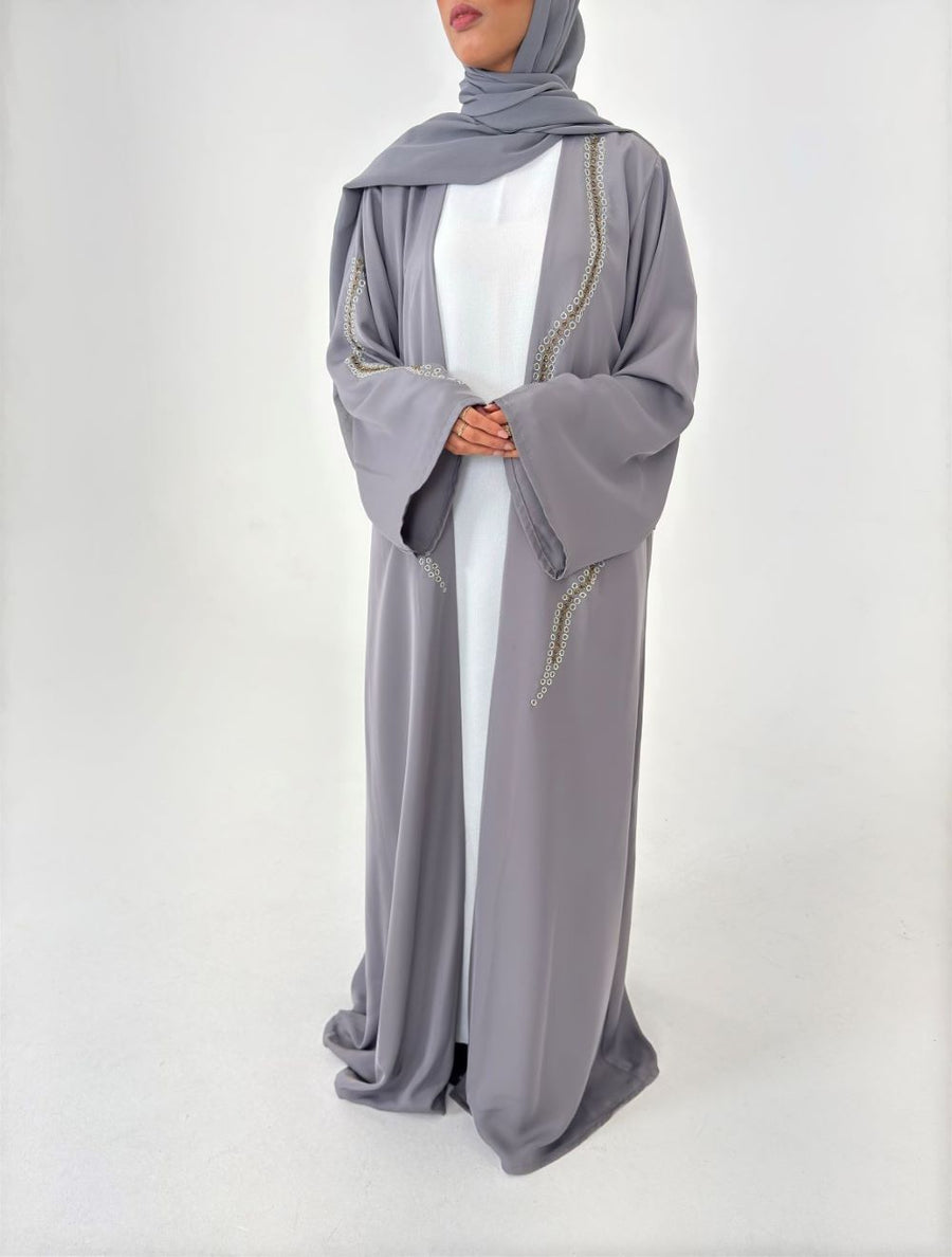 Woman wearing Amani's embellished grey duster style abaya with scarf