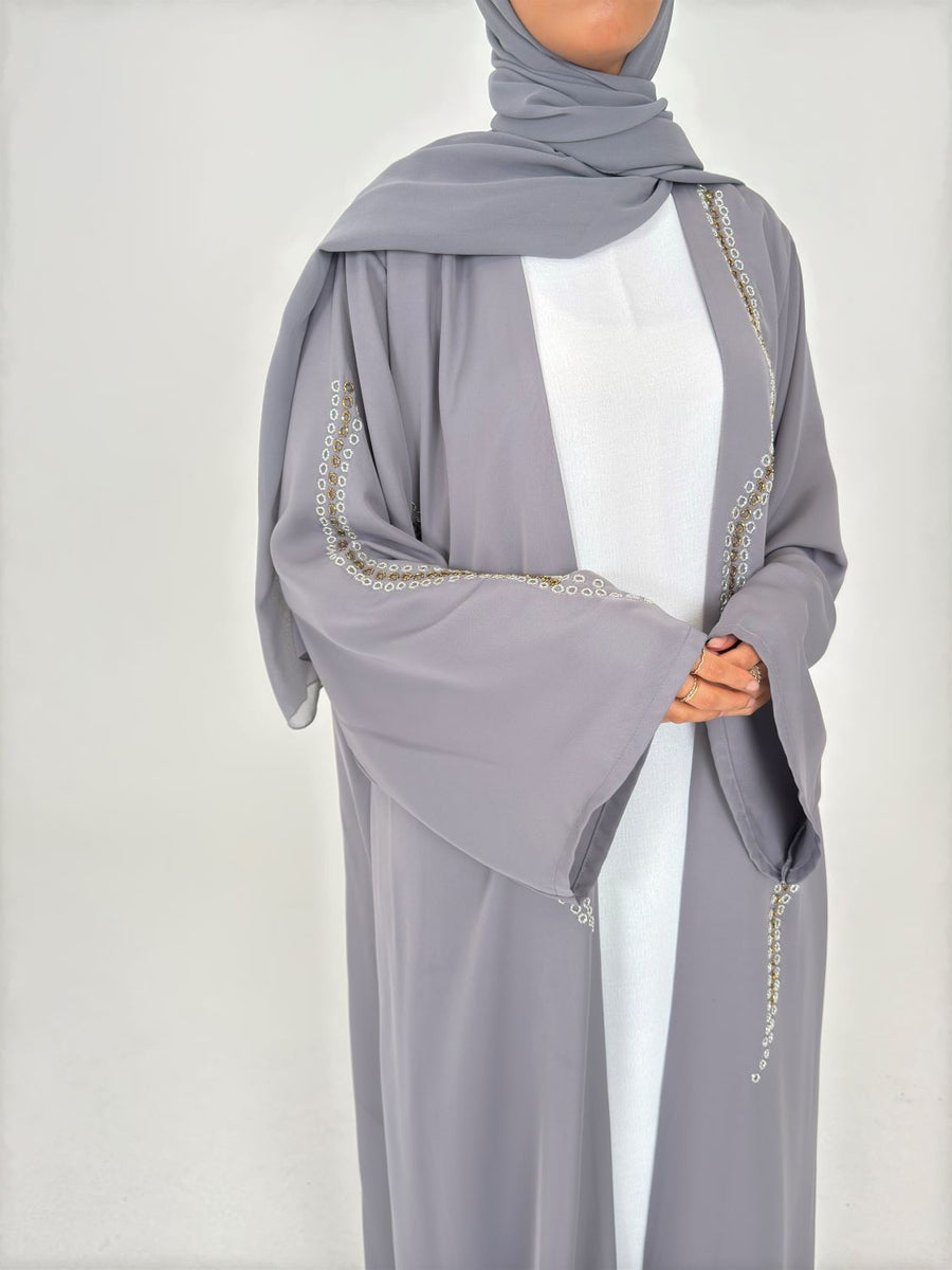 Fluid drape of the grey embellished duster abaya