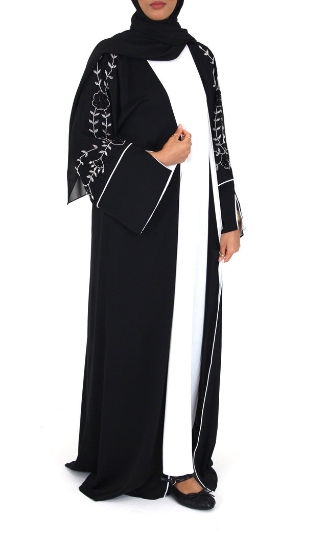 Woman wearing Amani's black floral embellished open abaya set
