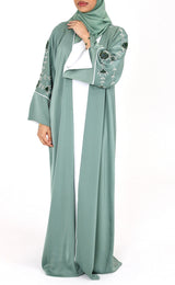 Woman wearing Amani's topaz green floral embellished open abaya set