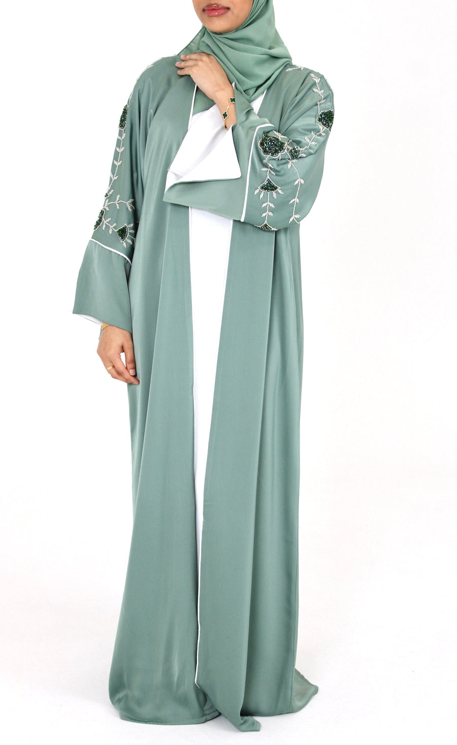 Woman wearing Amani's topaz green floral embellished open abaya set