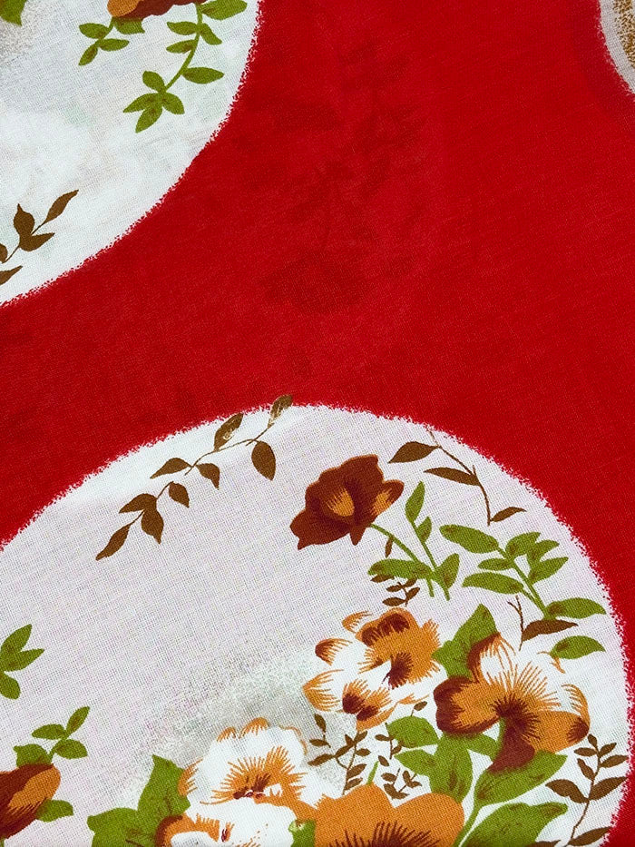Orange-red floral baati dress showing the warm floral print and loose cut