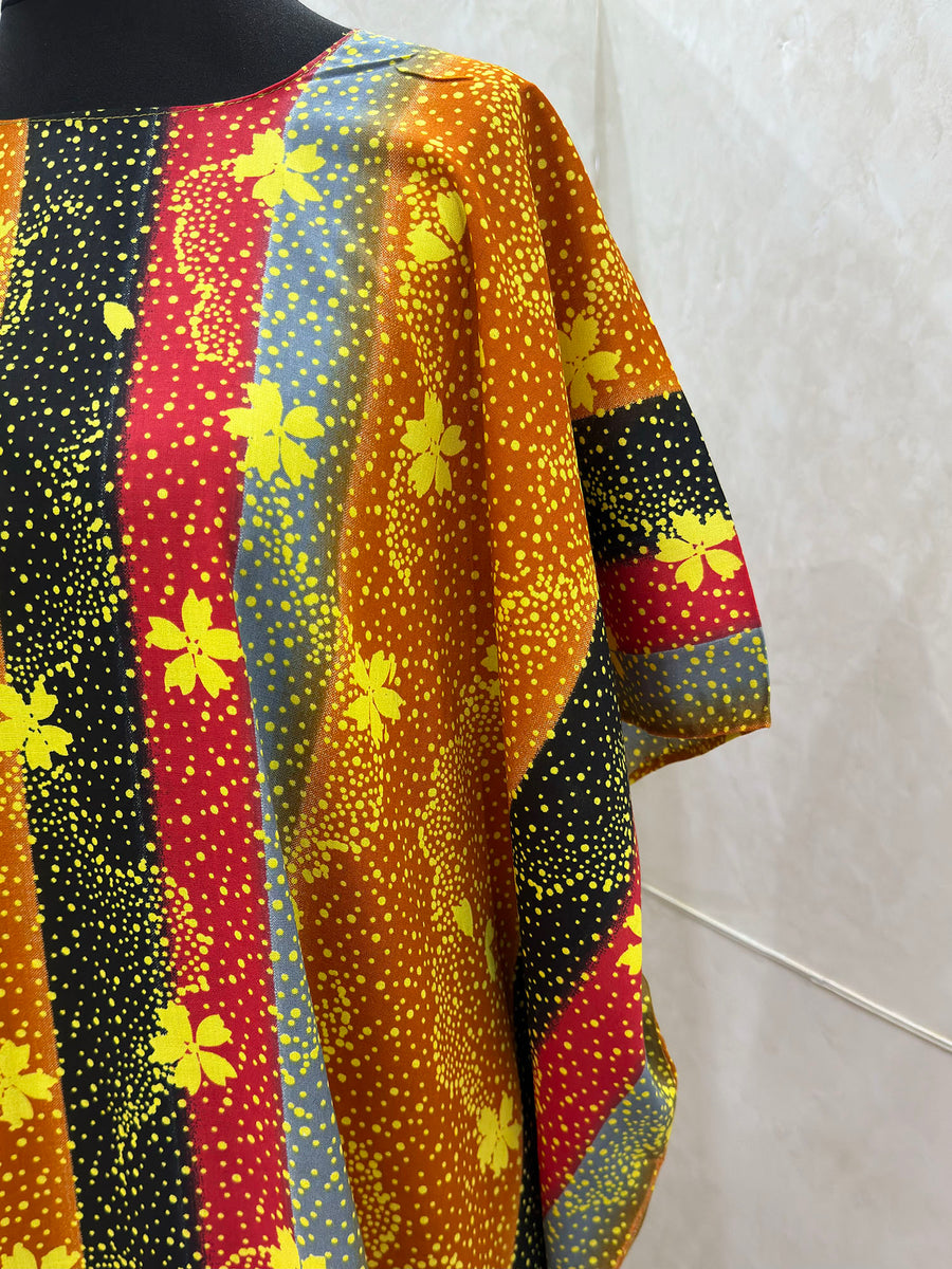 Orange floral print cotton baati dress showing the fabric and print detail