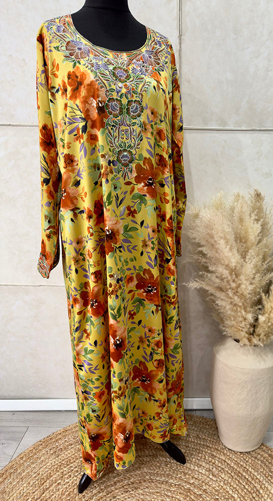 Woman wearing Amani's orange floral mukhawar dress with matching scarf