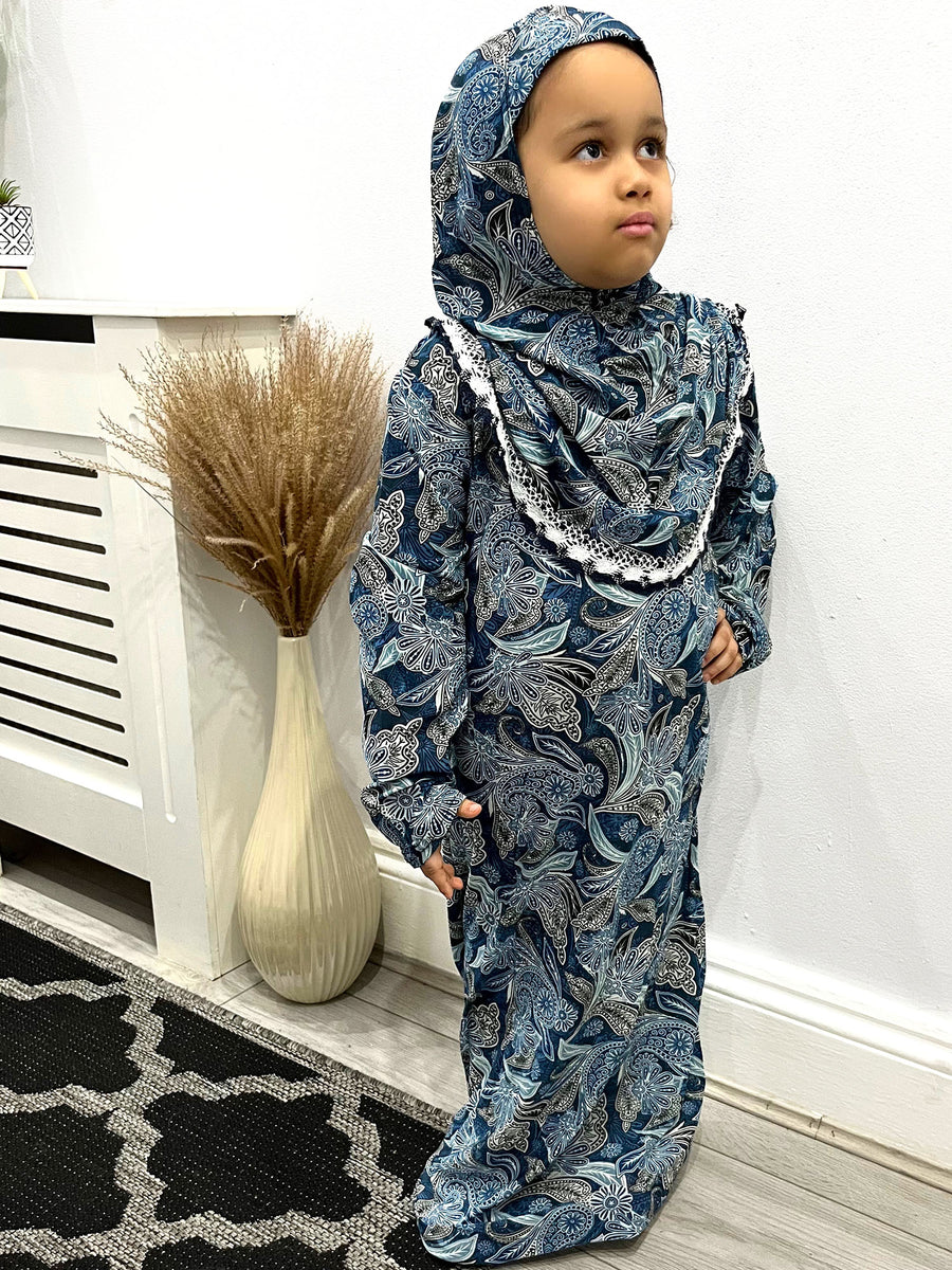 Little girl wearing Amani's floral print slip-on prayer dress with attached hijab