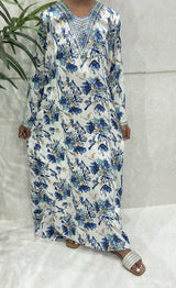 Little girl wearing Amani's blue floral mukhawar dress with crystal neckline