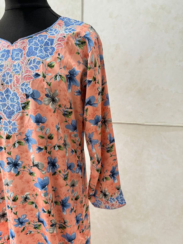 Little girl wearing Amani's peach floral print mukhawar dress