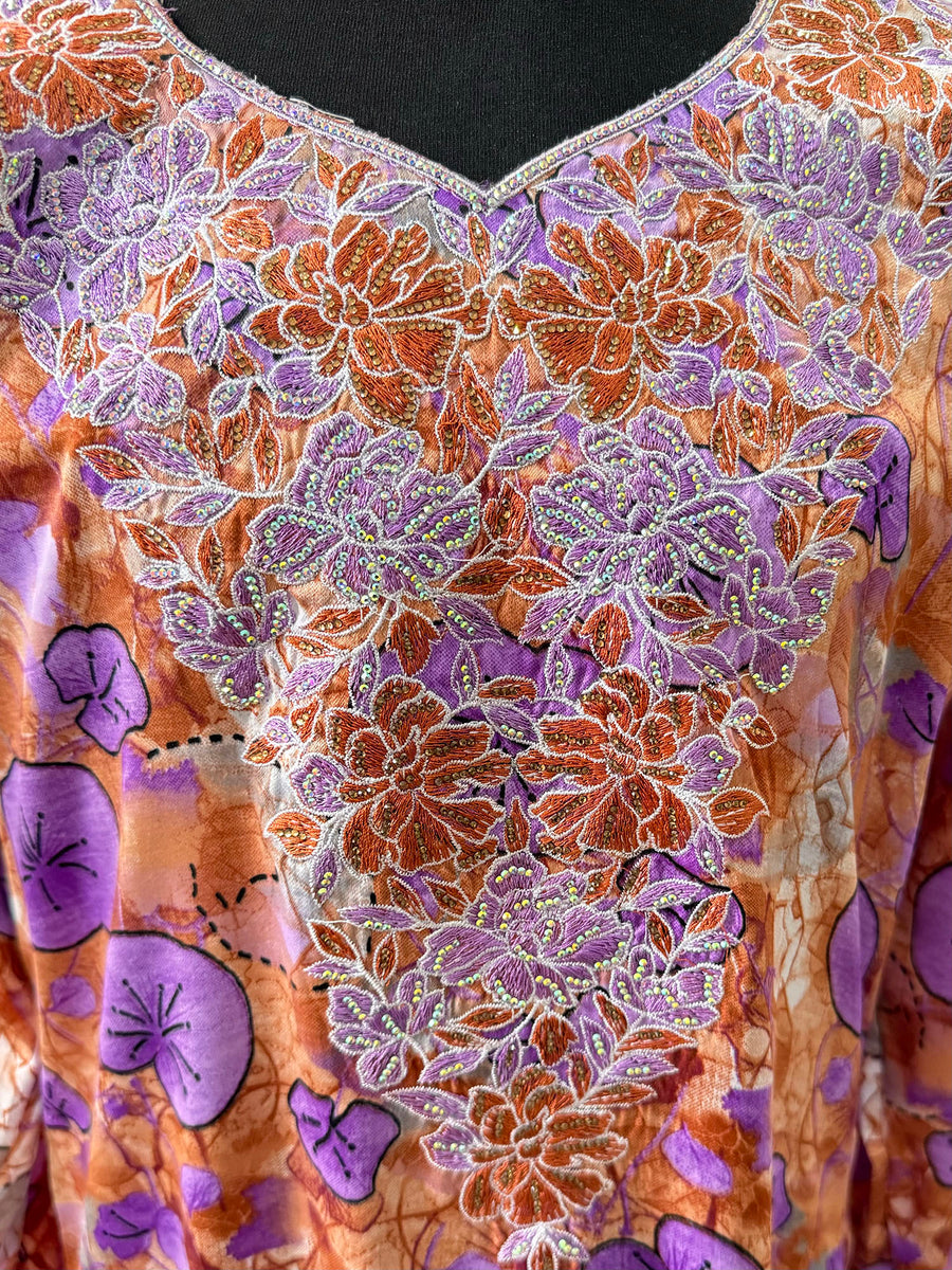Full-length view of Amani's purple floral mukhawar dress