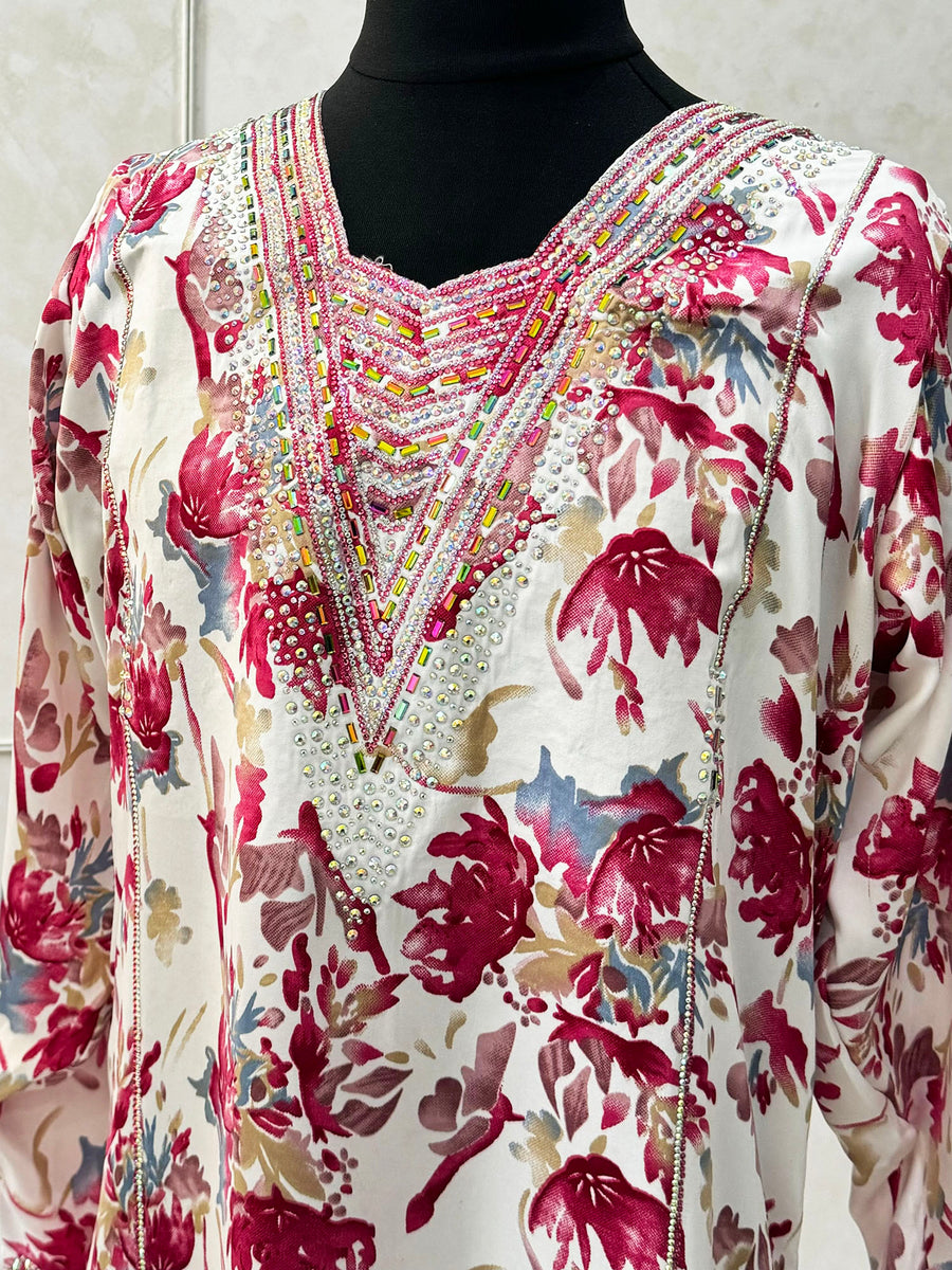 Red mukhawar dress showing the embroidered neckline and crystal detail