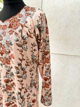 Little girl wearing Amani's soft peach floral mukhawar dress