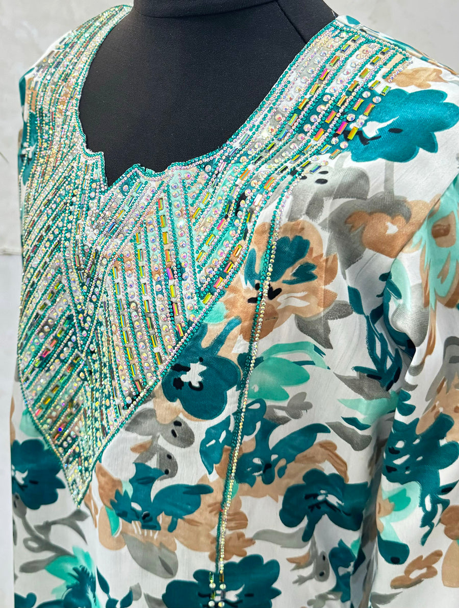Teal mukhawar dress showing the embroidered neckline and crystal detail