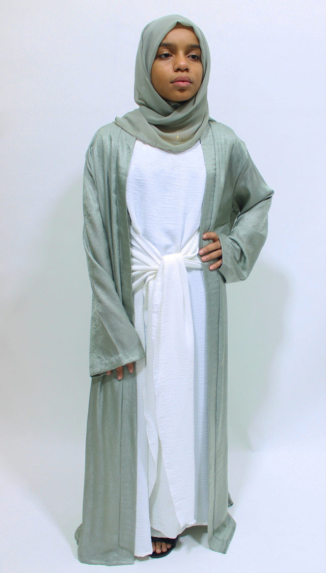 Girl wearing Amani's sage green open jacket abaya set with inner dress and scarf