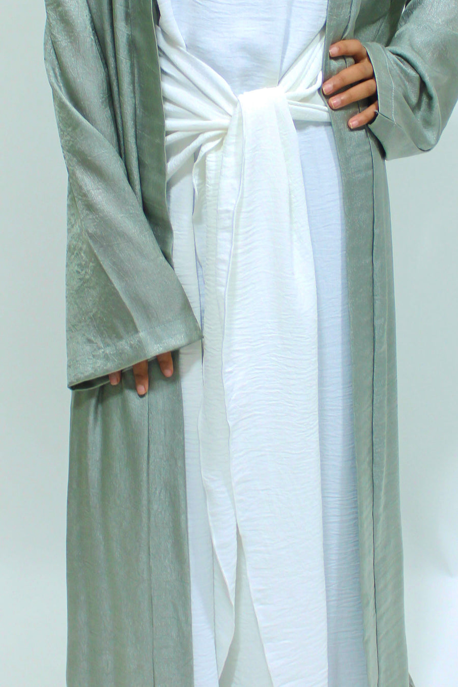 White front-tie inner dress included with the sage green abaya set