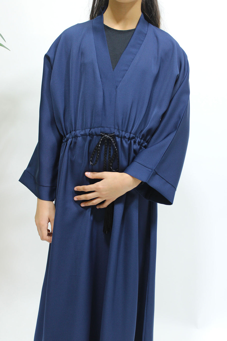 Full-length view of Amani's navy blue girls' draw string abaya