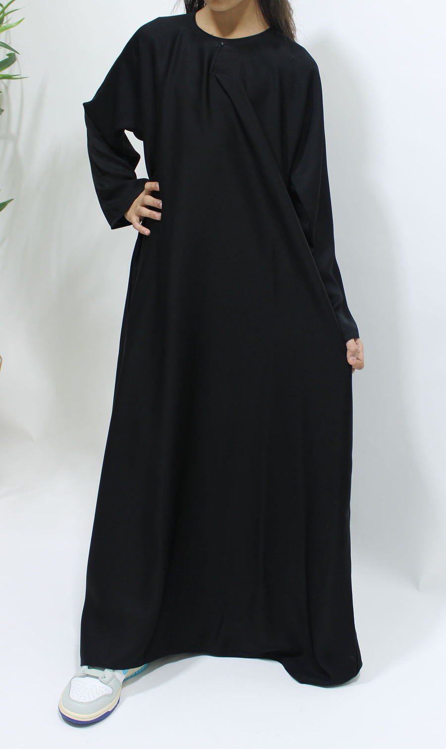 Amani's plain black Neda girls' abaya, side view