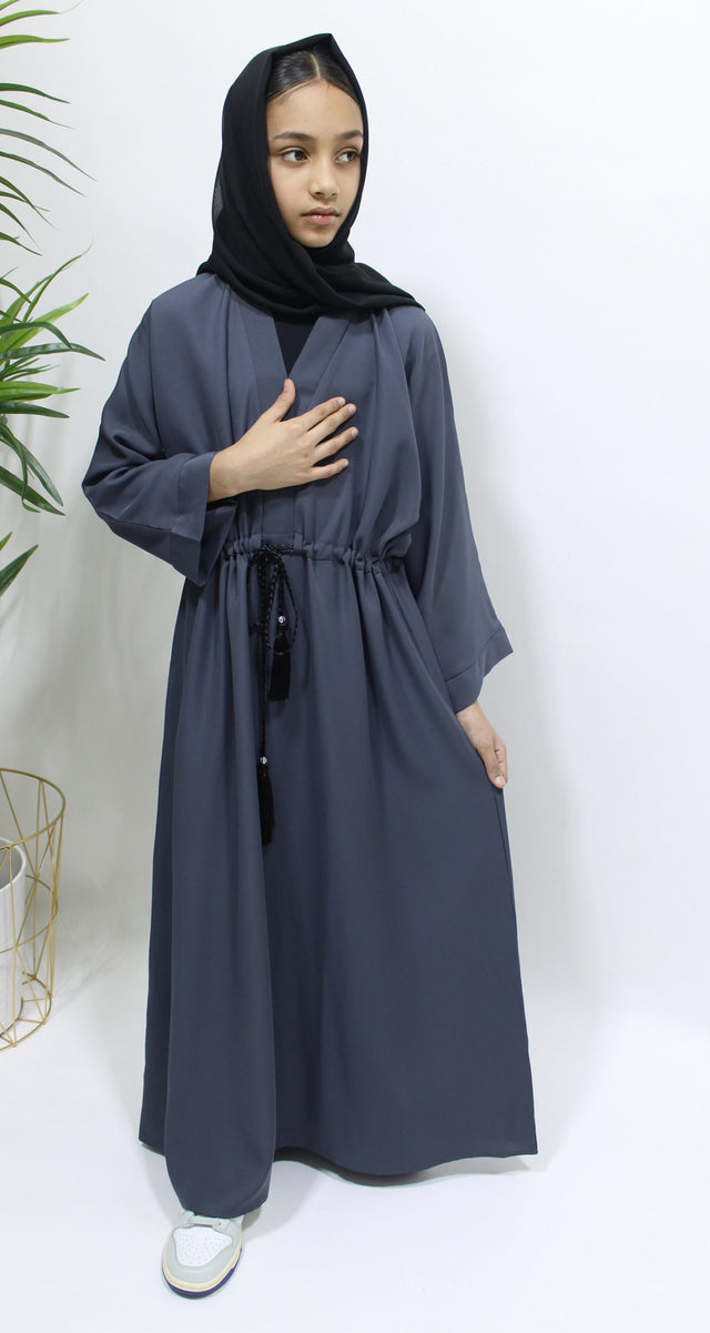 Girl wearing Amani's slate grey draw string abaya with matching scarf