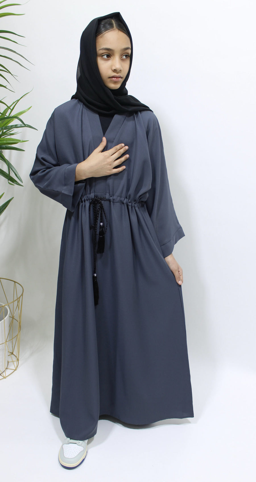 Girl wearing Amani's slate grey draw string abaya with matching scarf