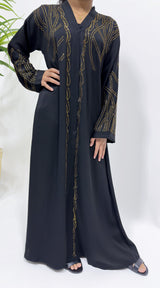Girl wearing Amani's black gold embellished open abaya with scarf