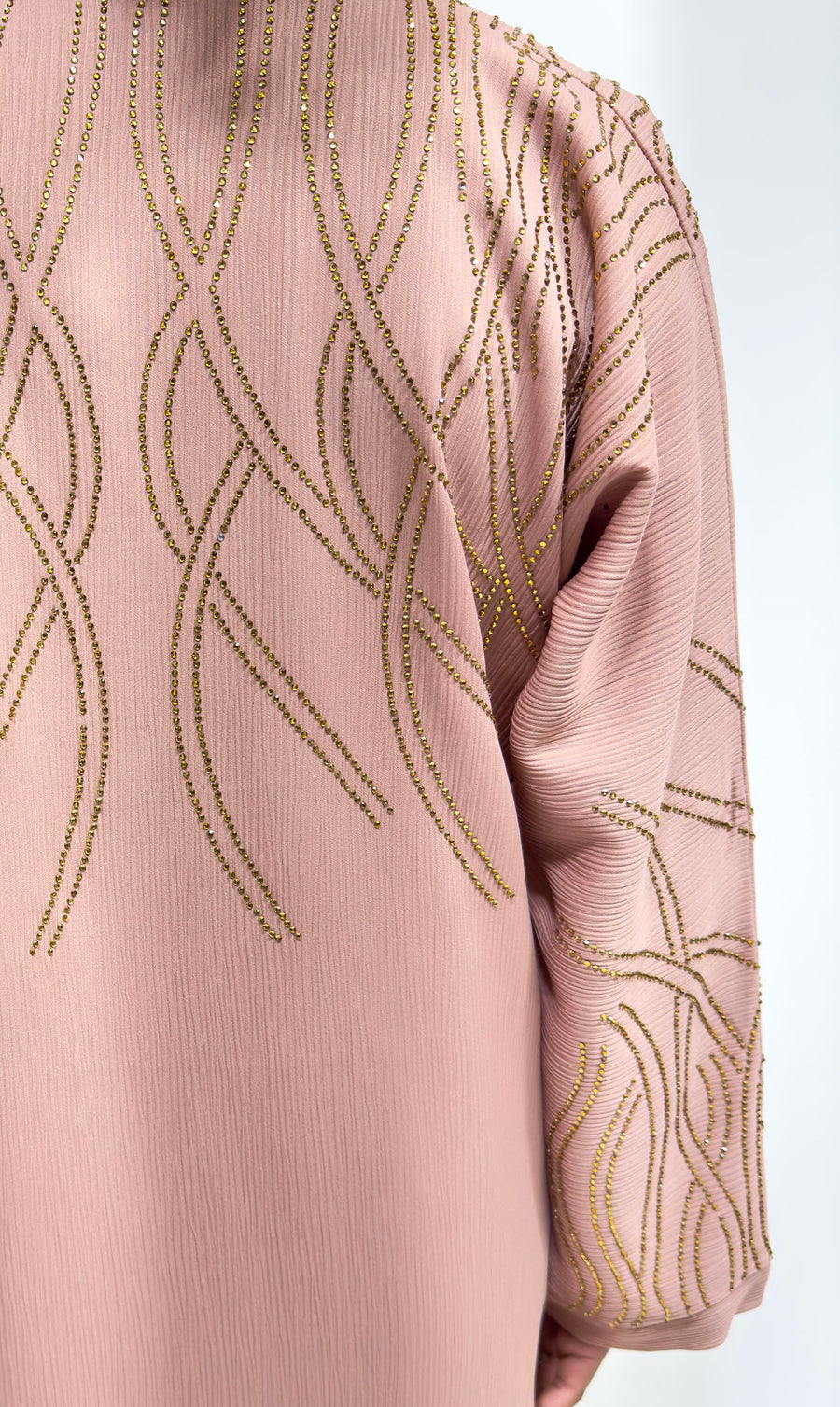 Full-length view of Amani's blush gold embellished open abaya