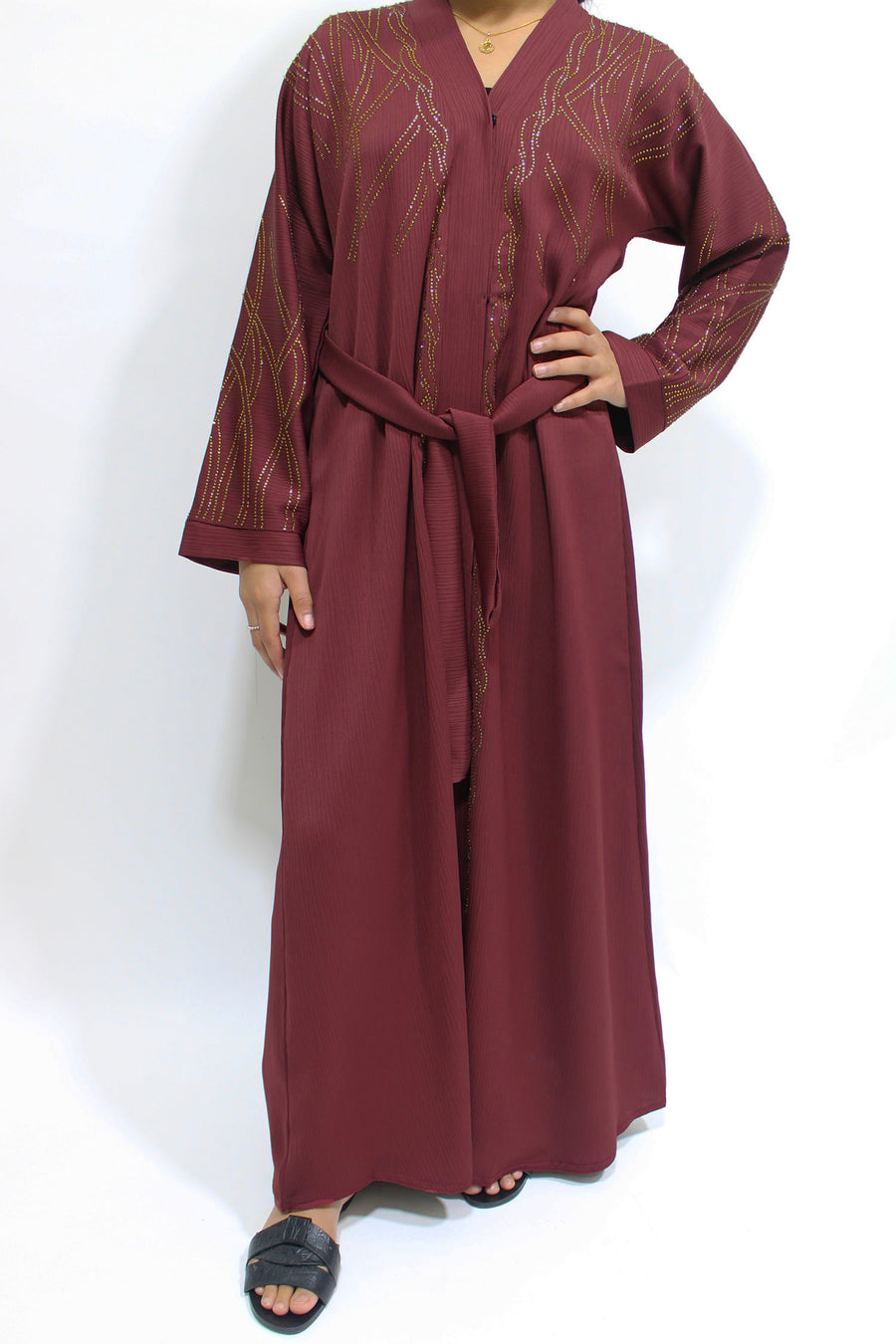 Gold diamante stone detail on the plum girls' open abaya