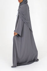 Woman wearing Amani's grey duster style open abaya with scarf