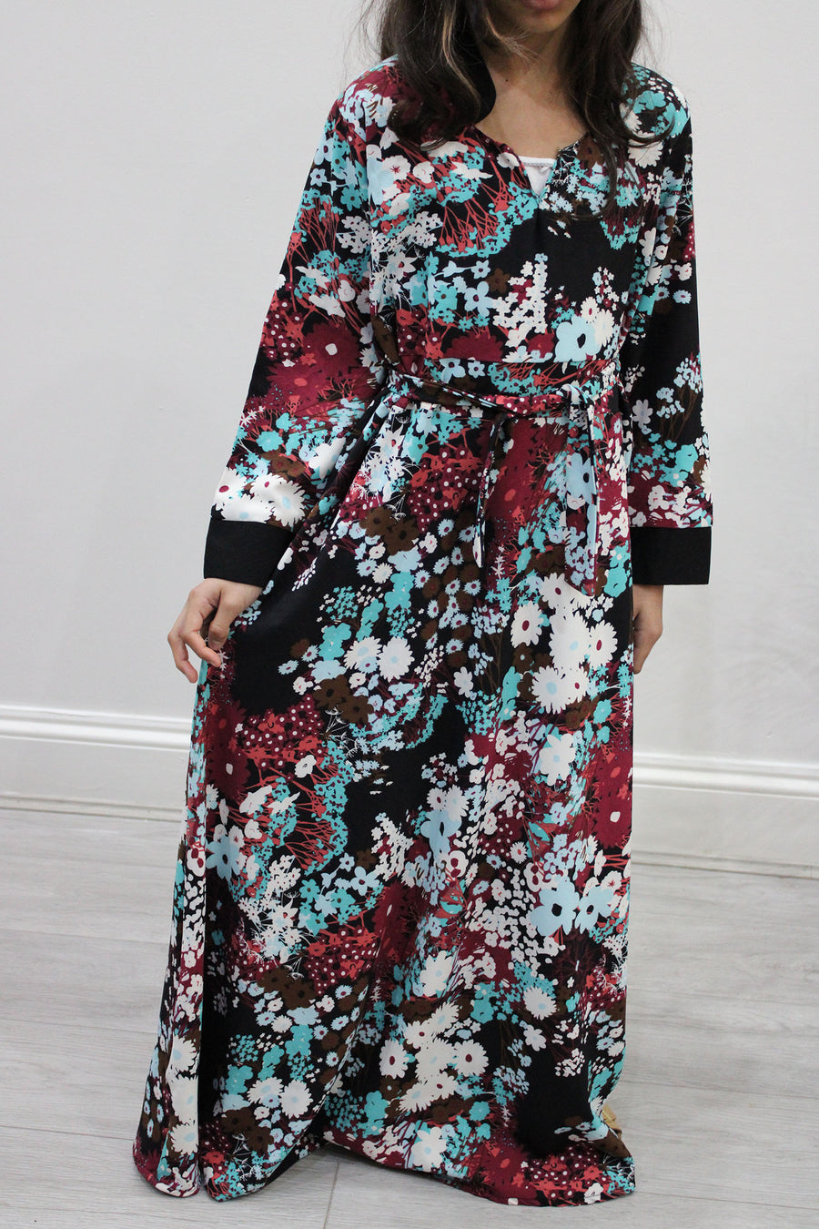 Full-length view of Amani's burgundy floral kids maxi dress