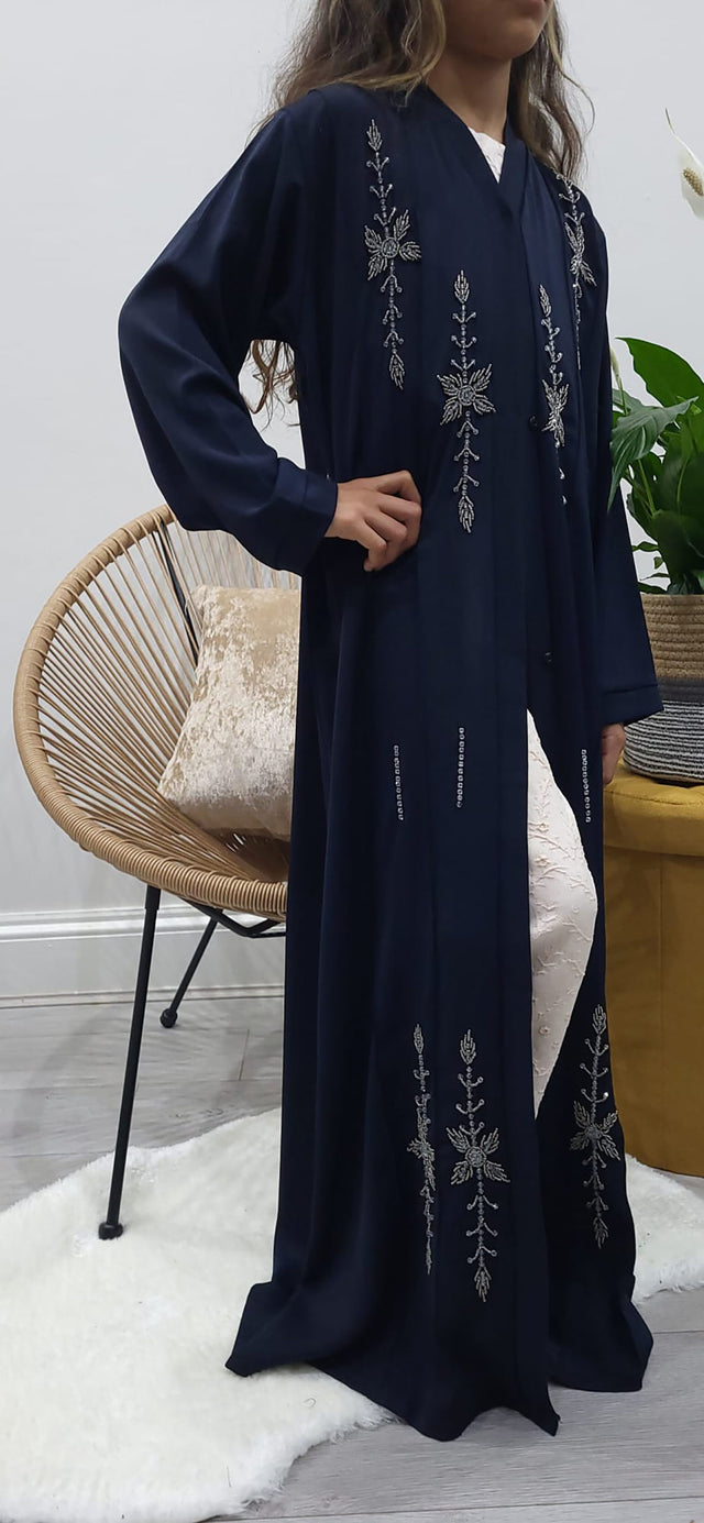 Girl wearing Amani's navy blue handmade beaded open abaya with belt and scarf