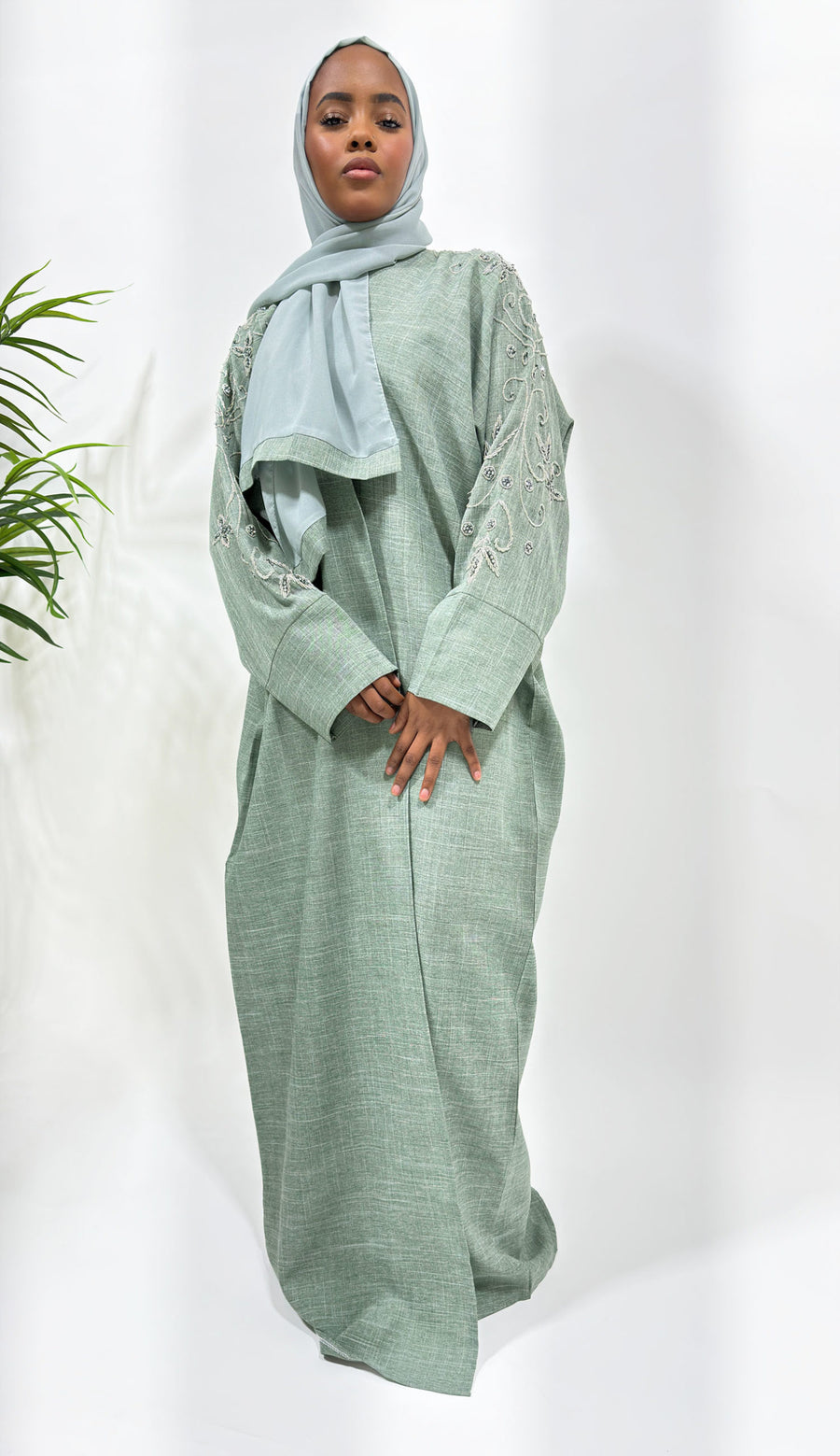 Greenish grey bisht abaya showing its relaxed open bisht silhouette
