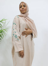 Nude linen blend bisht abaya worn open over a matching inner layer, front view