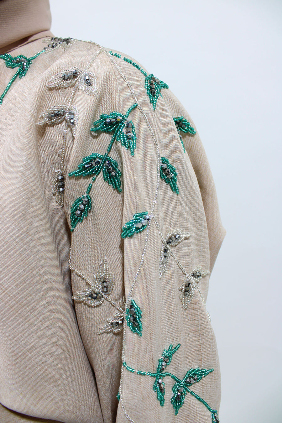Full-length nude linen blend bisht abaya styled with its matching hijab